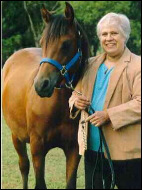 Woman standing with horse